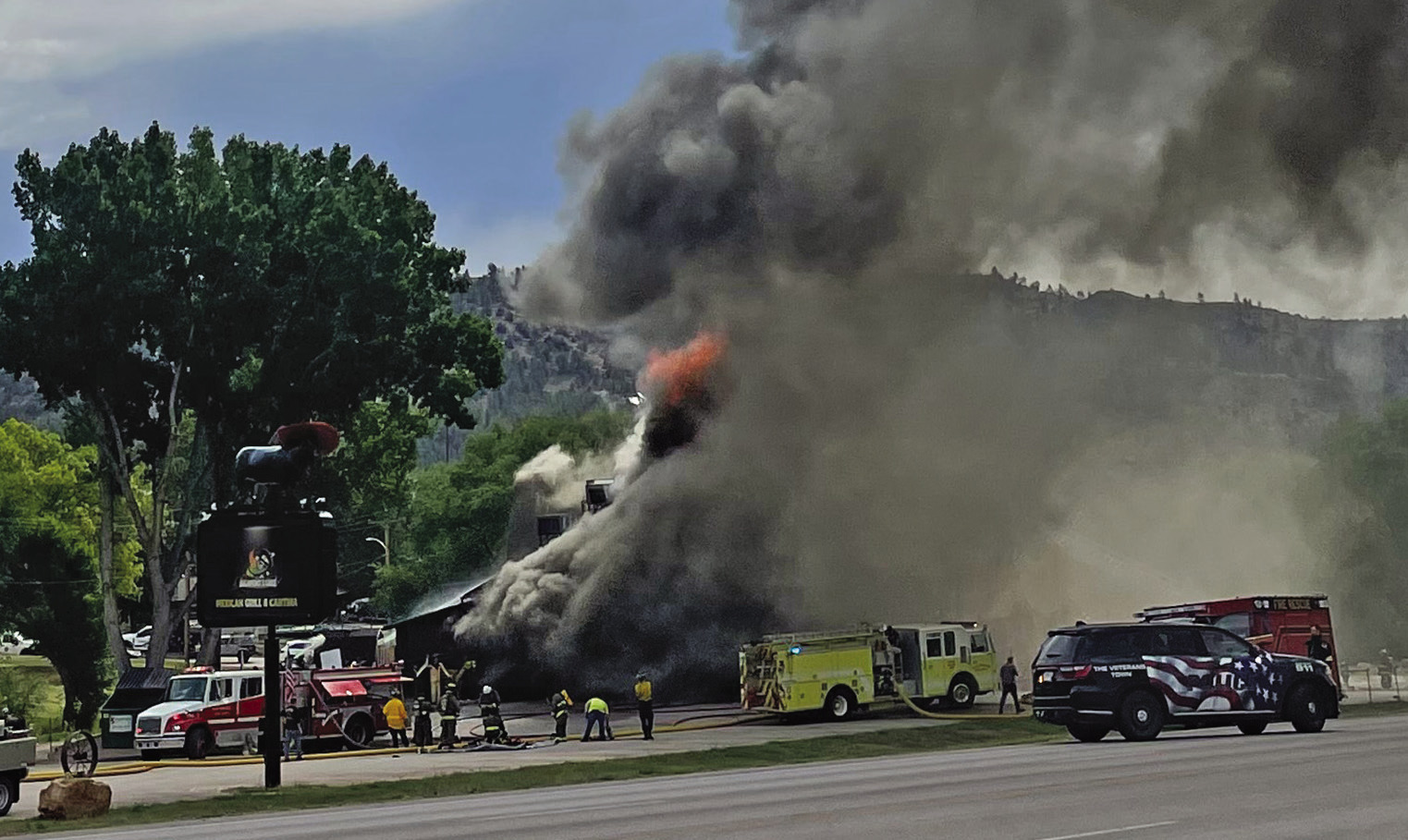 About an hour after the blaze was reported, and a half hour after fire crews had been pouting through a hole they cut in the roof, a thick cloud of dark smoke completely envelops the Jalapeno’s Grill building along Hwy. 18 in Hot Springs on Monday morning, July 6. Photo by Beth Bogart/Fall River County Herald-Star