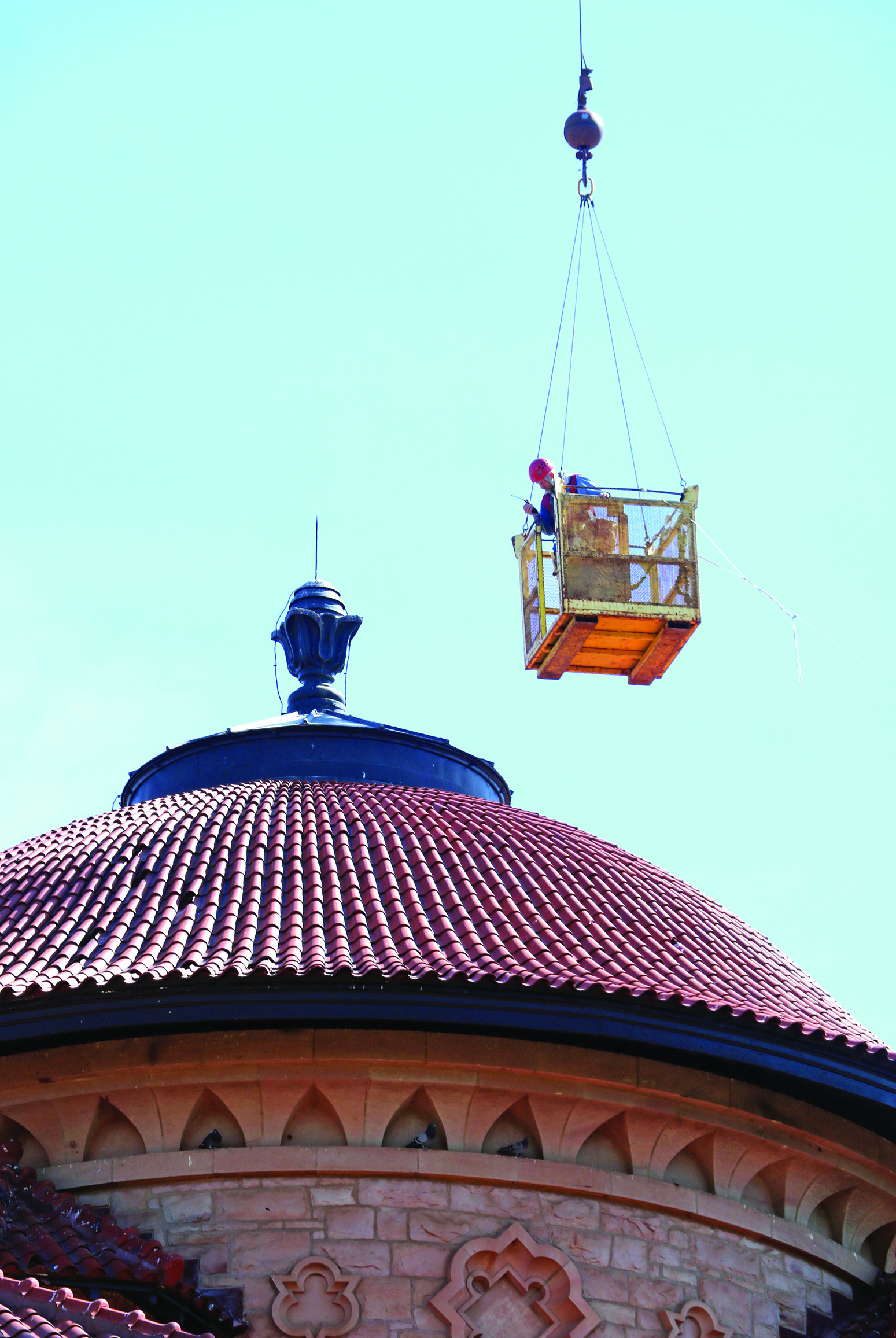 A worker is suspended by a large crane over the Hot Springs VA’s Domiciliary rotunda back on April 24. Photo by Brett Nachtigall/Fall River County Herald-Star