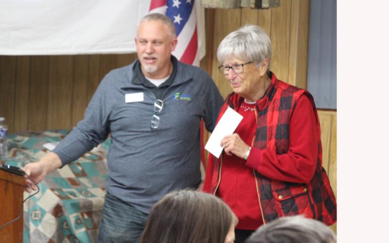 On behalf of Edgemont’s Senior Citizens Center, Mary Hollenbeck receives a $5,000 donation check from enCore’s Vice President Jay Douthit. Photo by Lance Borde/Fall River County Herald-Star