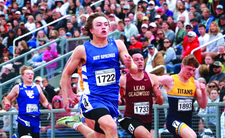 Hot Springs senior Braden Peterson breaks free from the pack during the 100-meter finals of the 2024 State Class “A” Track &amp; Field Championships in front of a packed grandstand at Howard Wood Field in Sioux Falls on Saturday morning, May 25. Photo by Brett Nachtigall/Fall River County Herald-Star