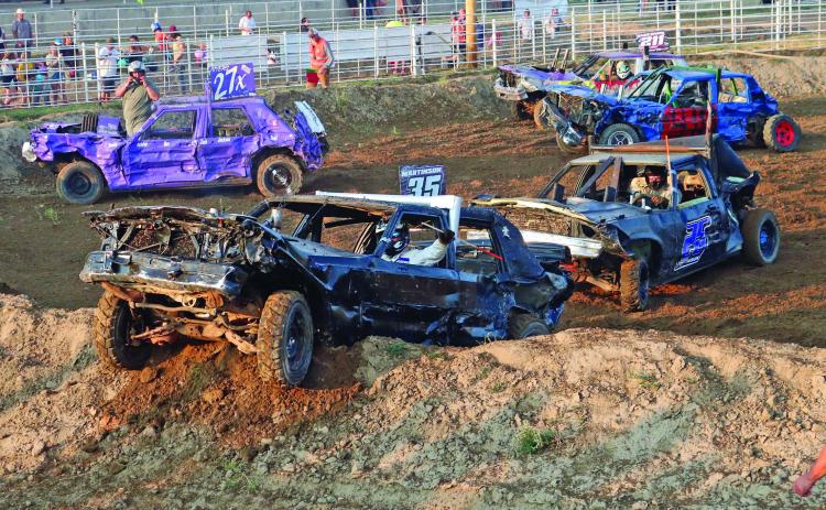 First-time derby competitor Jaren Martinson of Gillette, Wyo., pushes his uncle Kameron Martinson of Gillette, Wyo., onto the berm to win the Chain-Up Class of the 48th annual Demolition Derby of the Fall River County Fair on Friday, Aug. 2. See more photos on p. 12. Photo by Brett Nachtigall/Fall River County Herald-Star