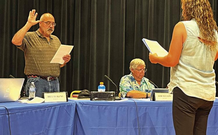 Former Hot Springs City Councilman Dave Burris gets sworn into office once again by Finance Officer Misty Summer-Walton during last week’s July 7 meeting at the Mueller Center where he was appointed to the seat by a 4-2 vote of the council Photo by Brett Nachtigall/Fall River County Herald-Star