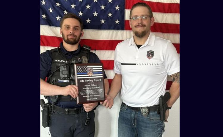 Officer Matthew Maxfield accepts an award from Chief Ross Norton. Courtesy photo