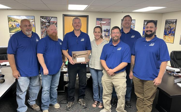 Last year’s Hot Springs School Board President Ryan Walz, third from left, holds the plaque which the 2023-24 board earned from the Associated School Boards of South Dakota (ASBSD) for meeting certain criteria in their ALL (Act. Learn. Lead.) recognition program. Other board members pictured include, from left, Dave Hoskins, Brian Jarding, (Walz), Katie Burchfield, Lloyd Morgan, Robert Preuss and Jason Mazzocchio. Photo by Brett Nachtigall/Fall River County Herald-Star