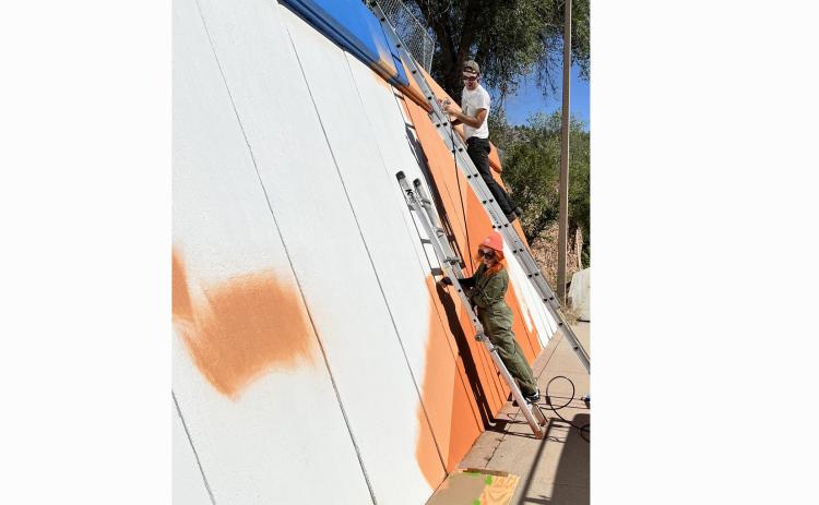 Last Friday morning, artists Matthew Carpenter and Morgan Fields put down the first layer of their mural design.