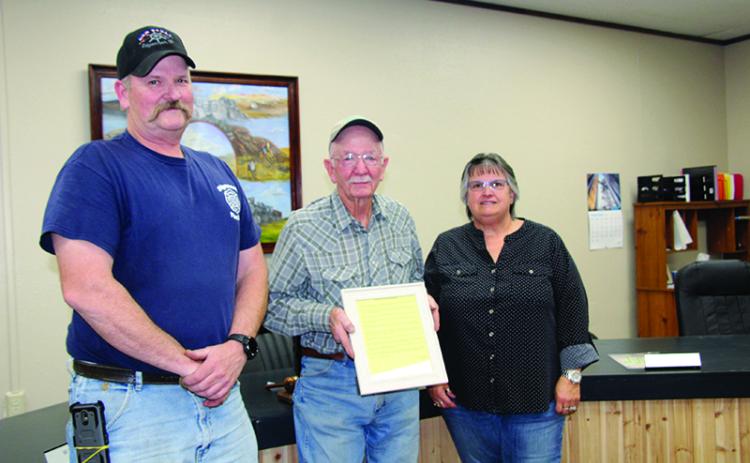 Edgemont City Council President Brent White, left, and Mayor Rheta Reagan, right, present George Darrow, center, with the official proclamation honoring Mr. Darrow. Photo by Linda Baird/FRC Herald Star