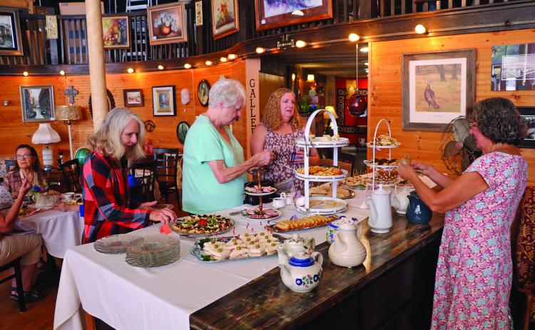 Some of the early attendees of last week’s Afternoon Tea get served inside the 2nd Chances store on North River Street. Photo by Brett Nachtigall/Fall River County Herald-Star