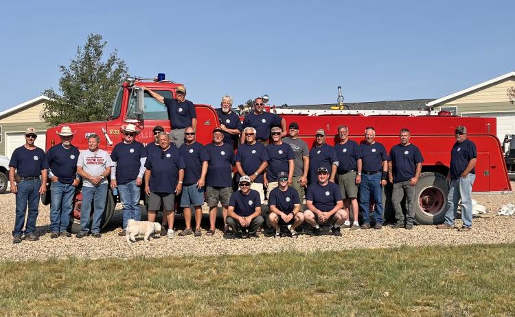 Several members of the Angostura Rural Volunteer Fire Department pose for a group photo while standing in front of one of the department’s five trucks. Courtesy photo