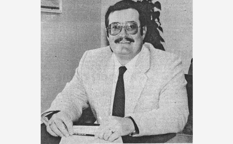 THEN AND NOW: Dick Dryden, above, is pictured at his desk in 1989 after being named the new manager of the Hot Springs branch of Black Hills Federal Credit. Below, Dryden is pictured at his desk last week, just a week prior to his planned final day at the credit union.
