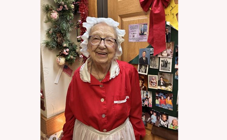 Gladys Pullins, a resident at Pine Hills, models her Mrs. Claus outfit, handmade by her 46 years ago, with hopes of making it two more years. Photo by Charity Maness