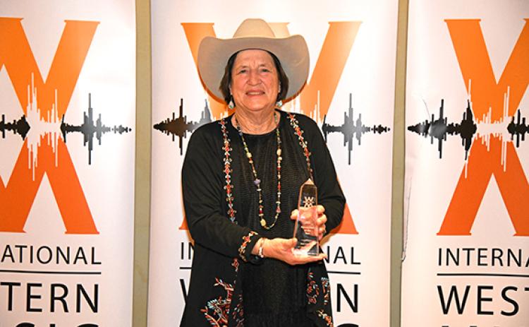 Local Poet Sherl Cederberg proudly displays her International Western Music Association Female Poet of the Year award. Courtesy photo