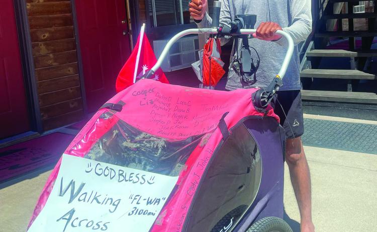 Camilo Ruiz (30) was four months into his solo trek from Orlando to Seattle, pushing his 100-pound cart, when he took a detour to Hot Springs for a respite enjoying the waters for a few days starting July 10. Photo by Beth Bogart/Fall River County Herald-Star