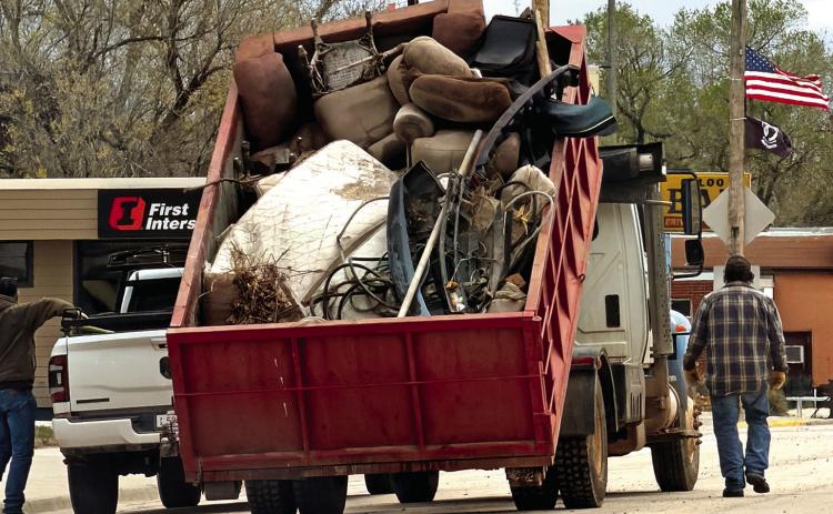 A dump truck hauls away furniture, mattresses and other refuse during the city clean up on Saturday, April 25. Photo by Savanna Simmons