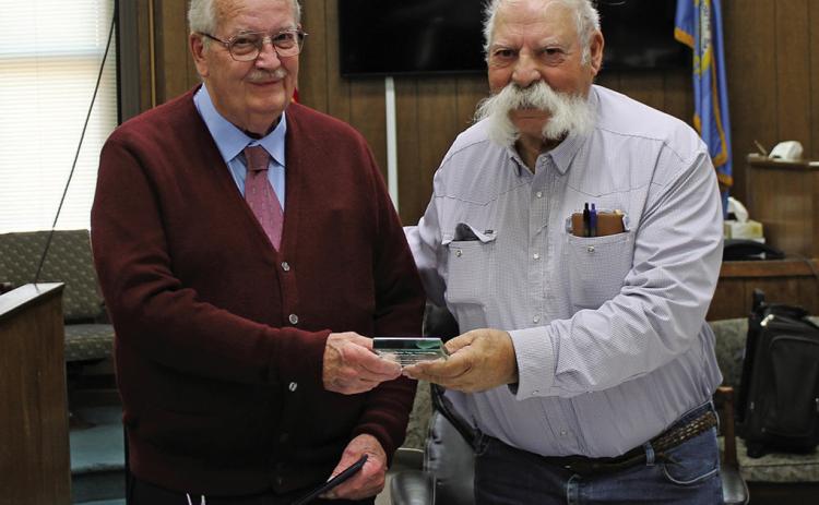 Fall River County Commissioner Joe Falkenburg, right, presents retiring Emergency Manager Frank Maynard a plaque declaring Franklin Maynard Day on Nov. 21. Maynard has worked for the county for 22 years and 11 months. Emergency Managers plan and direct response or crisis management activities, provide disaster preparedness training, prepare emergency plans and procedures and work with emergency response agencies. Photo by Cathy Nelson/Fall River County Herald Star
