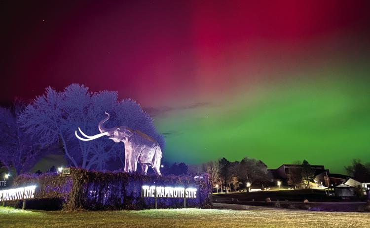 The mammoth known as “Digger” is illuminated not only by the usual blue spotlight of his surroundings at The Mammoth Site, along Hwy 18 in Hot Springs, but also the more unusual red and green lights of the aurora borealis, which was prevalent over much of the upper United States last Tuesday, Nov. 11. Photos by Brett Nachtigall/Fall River County Herald-Star