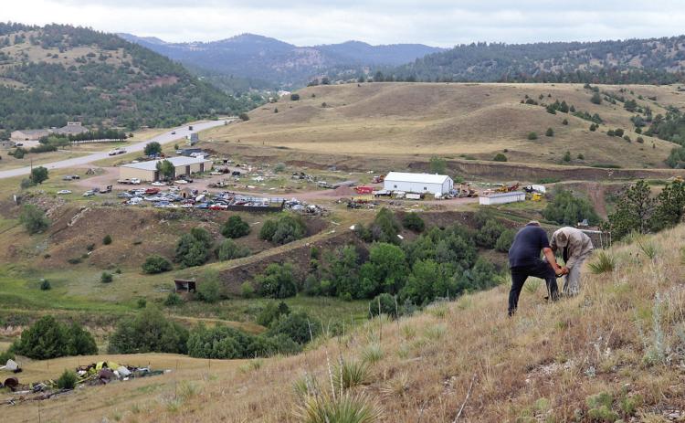 Workers with The Mammoth Site test the soil on a hill near Maverick Junction where large 4-foot x 8-foot letters spelling HOT SPRINGS will be erected below a mammoth statue to help direct travelers towards the community. Photos by Brett Nachtigall/Fall River County Herald-Star