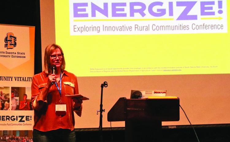 Andrea Powers with the Southern Hills Economic Development Corporation welcomes the more than 140 attendees of the SDSU Extension Energize Conference held in Hot Springs last week. Here, Powers speaks during a reception in the Mueller Center Theater but most of the breakout sessions were held in downtown businesses over the two day, May 22-23. Photo by Brett Nachtigall/Fall River County Herald-Star
