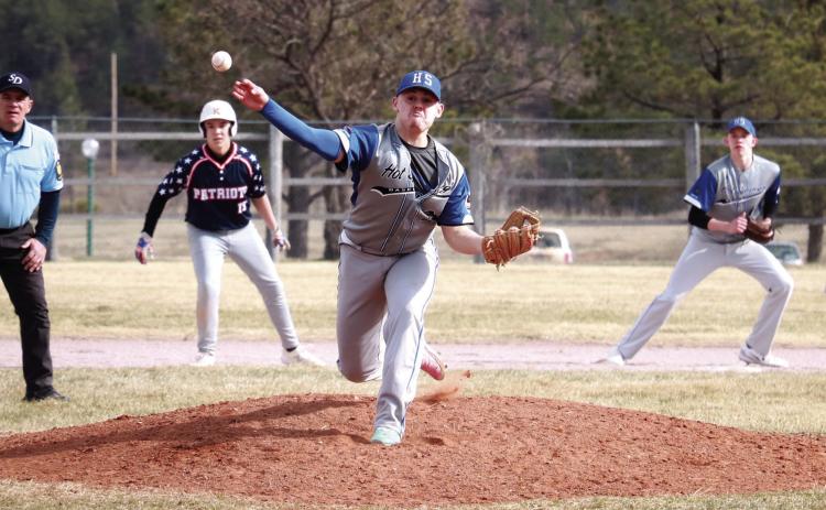 Hot Springs senior Blake Hanes hurls a ball towards home plate while a Douglas runner takes a lead off of second base during a game played at Butler Park last Friday, April 5. Hanes earned the win in the game after pitching five innings and earning four strike outs. He was also 3-for-3 batting in the game with one RBI. Photo by Brett Nachtigall/Fall River County Herald-Star