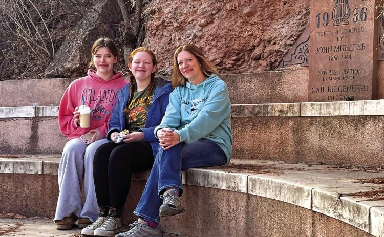 Linda Heggestad, right, the granddaughter of Florence Mueller, poses with her daughters Amy and Susannah while seated on the Kidney Springs bandstand which her greatgrandfather John Mueller, Sr., originally built and designed. Submitted photo