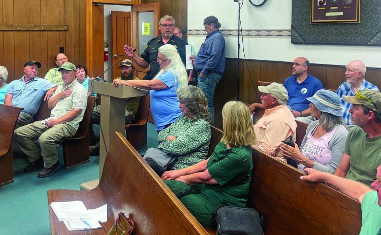 Sheps Canyon resident Jeannine Lecy read a petition requesting Fall River County Commissioners fulfill their pledge to improve the gravel road while roughly 20 other road residents came to support her; Sheriff Lyle Norton defended his department’s efforts to patrol for speeders on the road. Photo by Beth Bogart/Fall River County Herald-Star