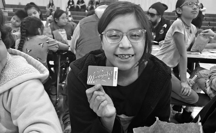 Sara Brown Bull shows off the $25 gift card she won at Friday Fun Bingo on February 23 at the Oelrichs School. Photo by Katie Merdanian/Fall River County Herald/Star