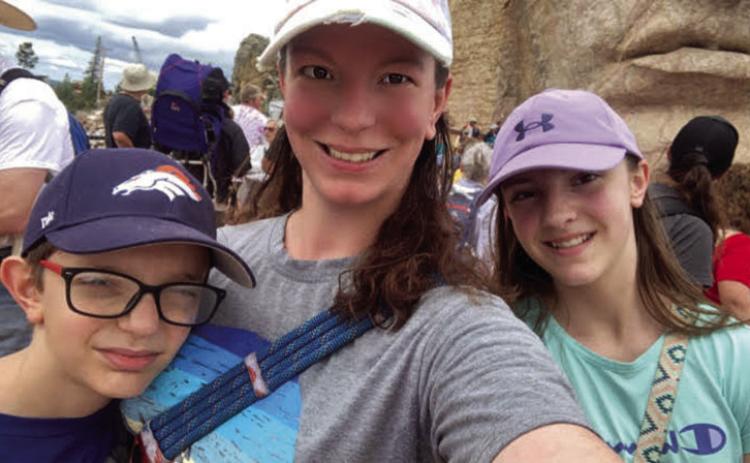 Hot Springs’ Rachel Nilles, who is a school teacher in Oelrichs, poses for a selfie with her children, Leon and Mira Palyan, atop the Crazy Horse Memorial during a recent Volksmarch. In April 2024, while helping coach a youth soccer practice, Nilles suffered a form or an aneurysm in her chest within the walls of her aorta. Courtesy photo