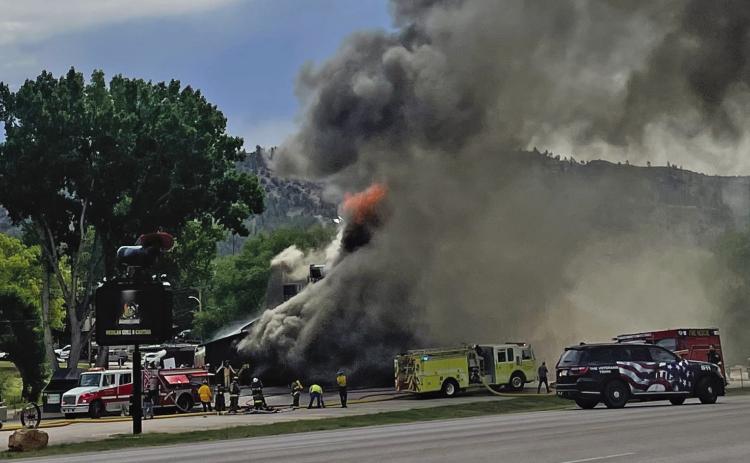 About an hour after the blaze was reported, and a half hour after fire crews had been pouting through a hole they cut in the roof, a thick cloud of dark smoke completely envelops the Jalapeno’s Grill building along Hwy. 18 in Hot Springs on Monday morning, July 6. Photo by Beth Bogart/Fall River County Herald-Star