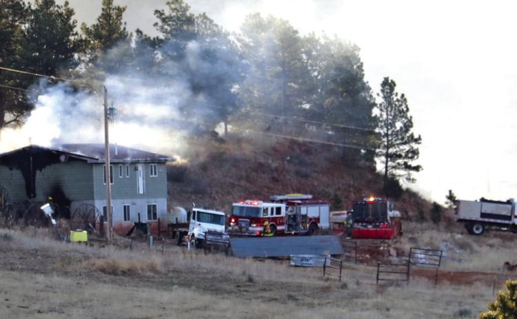 In this photo taken at 7:19 a.m. on Thursday, March 21, crews are still knocking down the flames of a house fire located north of Hot Springs at 27097 Ridgeview Springs Road. Despite the fire believed to have been fully extinguished later that evening, the home reignited overnight and was completed burned to the ground by the morning of March 22. Photo by Brett Nachtigall/Fall River County Herald-Star