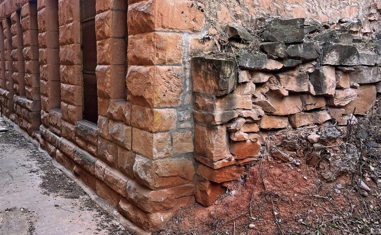 This photo behind City Hall of the exterior southeast corner of the building shows some of the tuckpointing and masonry repairs that need done to the sandstone blocks, due to erosion and drainage issue. Photo by Brett Nachtigall/Fall River County Herald-Star