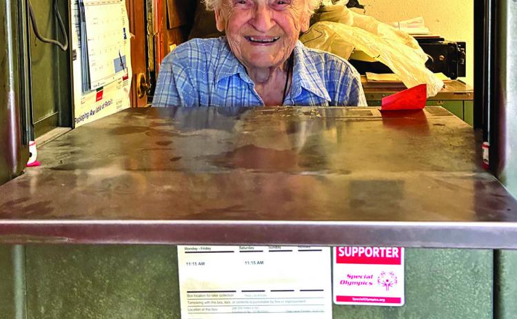 Sue Olofson greeted her customers through this mail window for the past 30 years at Smithwick Post Office when they came to get their mail, drop off packages or just stop in to chat. Photo by Charity Maness / Fall River County Herald Star
