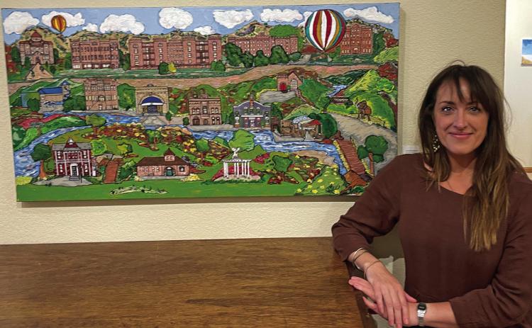 Silk Road restaurant co-owner Merri Nadeem had long hoped to see one of her paintings in a gallery; her fanciful depiction of Hot Springs hung at the Art House for only a brief period before being purchased. Photo by Beth Bogart/Fall River County Herald-Star