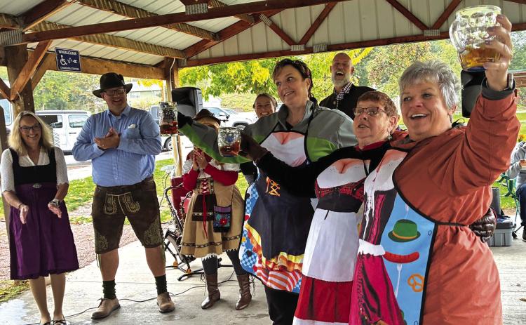 Friends Christa Achtenberg, Sharon Kearns and Carla Kreuger take home a win as German Beer Girls while other contestants Heather and Bob Pruess, Vanessa Soulek, and Jennifer and Brian Bengs applaud. (Photo by Charity Maness / Fall River County Herald Star)