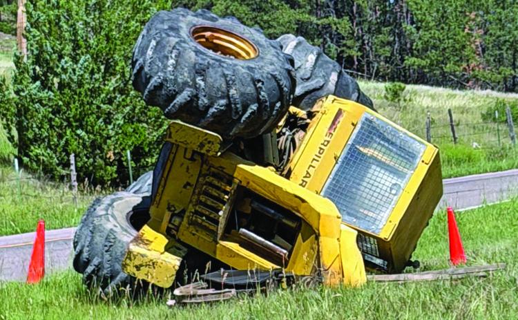A Caterpillar skidder lays on its side along Hot Brook Canyon Road after it slipped off of a flatbed trailer while being unloaded last Thursday, July 16. Photo courtesy Andrew Kerr