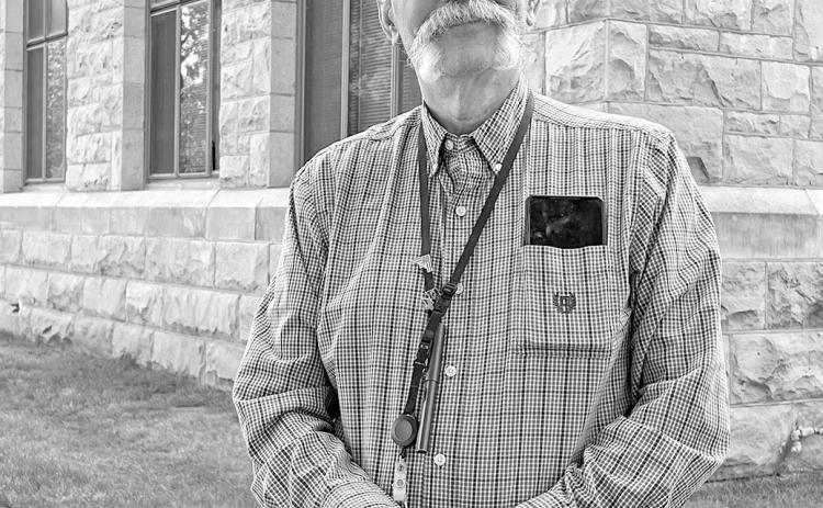 New secondary principal Steve Helgeland, a native Mt. Vernon, S.D., stands in front of the Hot Springs High School building. Photo by Brett Nachtigall/Fall River County Herald-Star