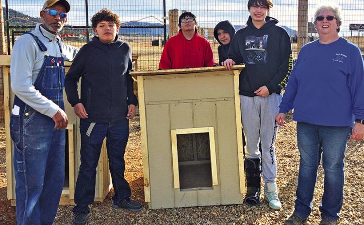 Buff Tewahade, woodshop teacher at the Oelrichs School, and four of his students meet with Connie Geiser from the Battle Mountain Humane Society to donate two dog houses built by the class. Photo by Katie Merdanian/Fall River County Herald-Star