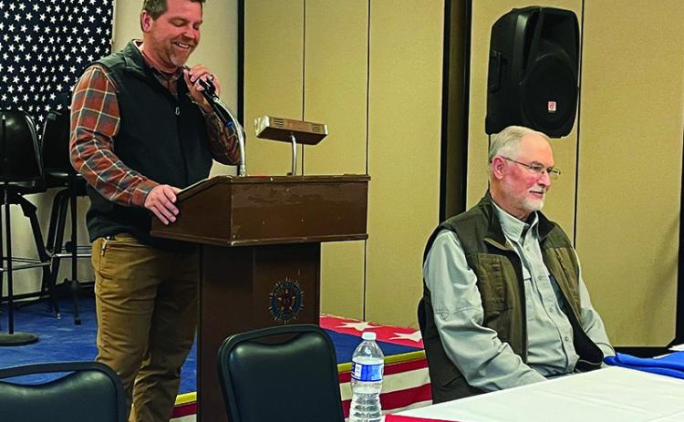 The partnership between SD Game, Fish and Parks, as represented by Mike Klosowski (standing) and gun club president Gary Owens (seated), is vital. Photo by Beth Bogart/Fall River County Herald Star
