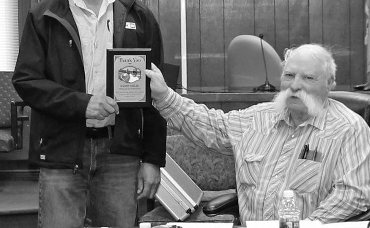 Randy Seiler accepts a plaque from Fall River County Commission Chair Joe Falkenburg during last week’s county commission meeting. Photo by Cathy Nelson