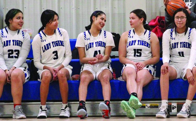 The Lady Tigers, from left to right: Blanche Mousseaux, Nalolah Warrior, Katelyn Her Many Horses, Amelia Her Many Horses, and Isabella Her Many Horses, take a much-needed rest during halftime of Friday night’s game against Edgemont. Photo by Masha Fehr