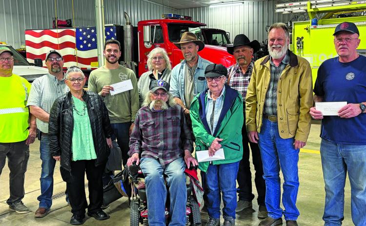 Members of the Fall River Thrift Store board of directors (center) are surrounded by representatives of several area volunteer fire departments, all of whom received checks for at least $1,000 each. In all, the thrift store donated a total of $12,000 to Angostura, Ardmore, Cascade, Edgemont ($2,000), Hot Springs ($3,000), Minnekahta, Oelrichs, Oral and Smithwick. Courtesy photo