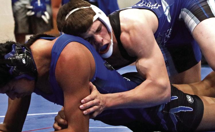 Hot Springs eighth-grader Thor Fish, top, wrestles Zuya Romero of Red Cloud in the 157 pound semifinals of the Black Hills Conference tournament in Case Auditorium last Friday afternoon. Fish would go on to win this match with a 2:41 pin and later claim a BHC title. Photo by Brett Nachtigall/Fall River County Herald-Star