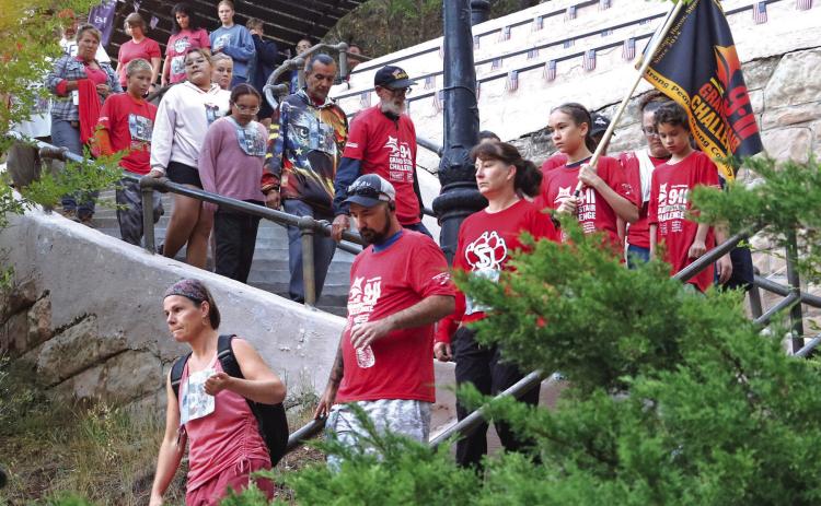 Margaret Chicoine, lower left, leads a group of participants during the Flight of Silence as part of the 12th annual 9-11 Grand Stair Challenge held last Thursday morning. Photo by Brett Nachtigall/Fall River County Herald-Star