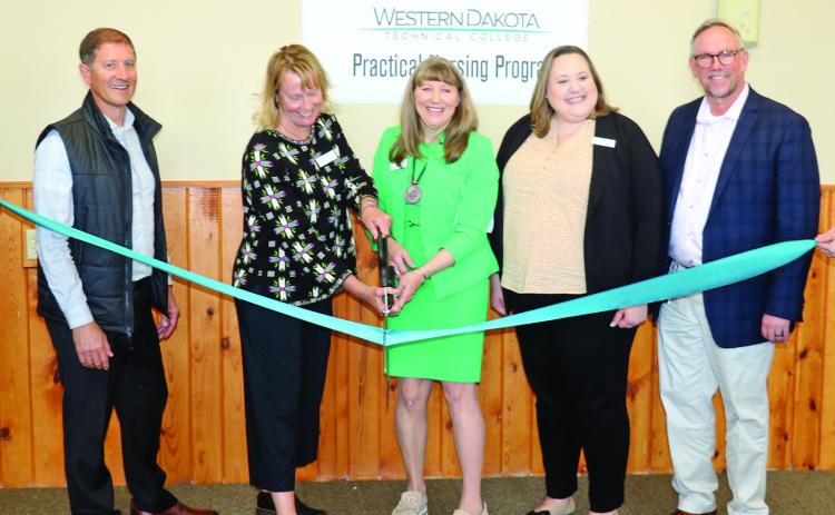 WDTC President Ann Bolman and SHEDCO Executive Director Andrea Powers prepare to cut the ribbon to signify the opening of a much-anticipated Practical Nursing Satellite Program at the State Veterans Home in Hot Springs. Also pictured, from left, are Jeremy Schultes with FRHS Administrator, WDTC Nursing Program Director Krysten Hybertson and State Home Superintendent Chuck Johnson. Photo by Brett Nachtigall/Fall River County Herald-Star