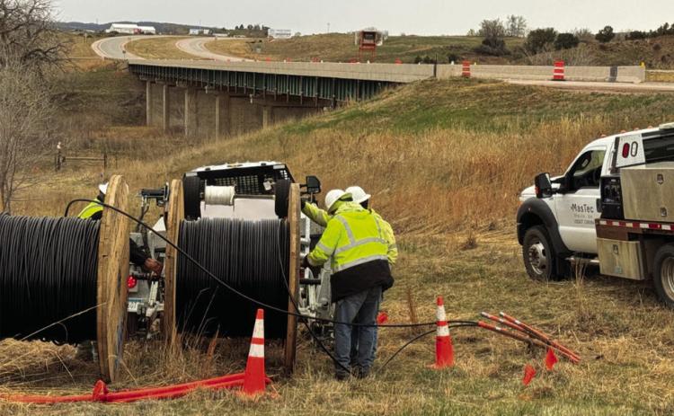 Golden West representatives prepare to bore under the Cheyenne River Bridge as part of the fiber optic expansion. Photo by Garland Wright