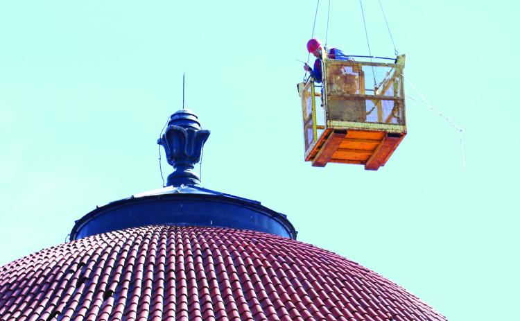 A worker is suspended by a large crane over the Hot Springs VA’s Domiciliary rotunda back on April 24. Photo by Brett Nachtigall/Fall River County Herald-Star