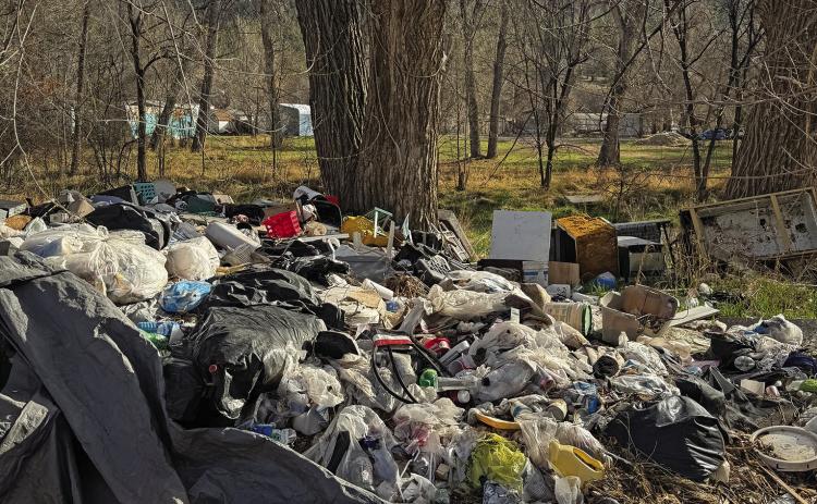 Large piles of trash adorn the property at 1270 S. 6th Street, located along Fall River and near a trailer park in the southeastern part of Hot Springs. Photo courtesy HSPD