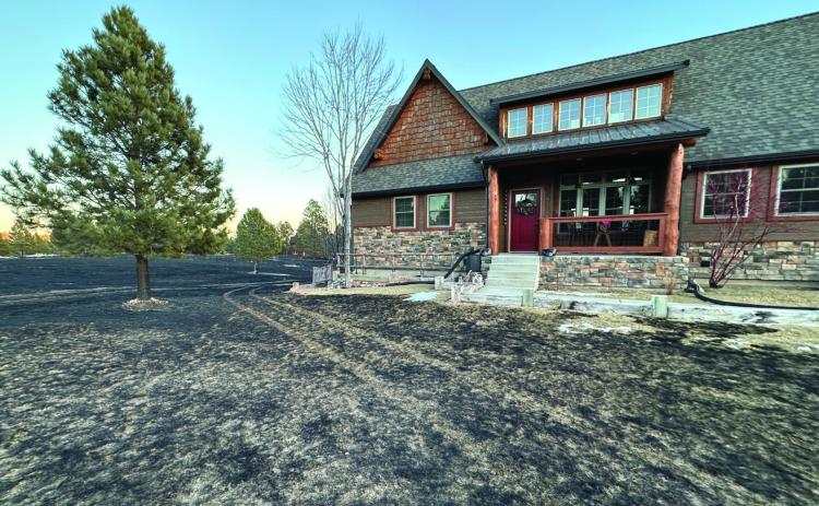 Dramatically illustrating SD Wildland Fire’s advice to replace mulch with a stone perimeter, a Hermosa home survived intact even though the quickly-moving Skyline Fire last year burned all around the property before firefighters even arrived. Courtesy photo
