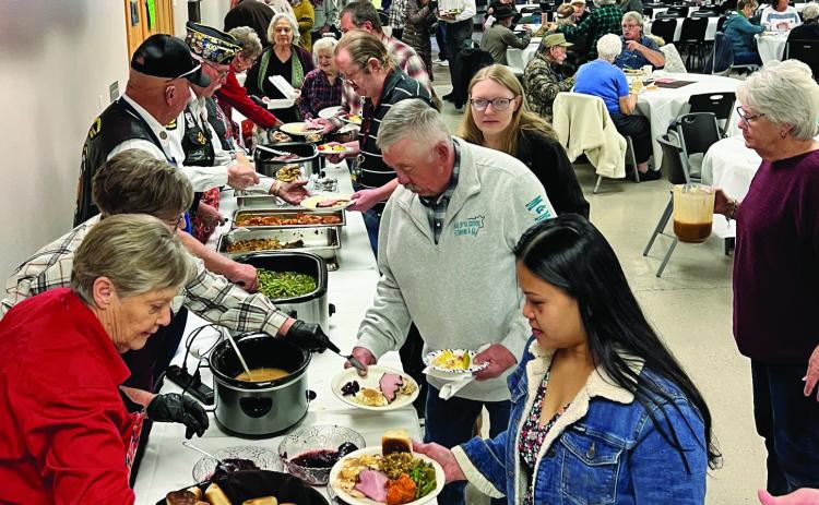 The line was long but the mood was merry as more than 550 people were served and enjoyed a Thanksgiving Feast at the American Legion on Thanksgiving Day. Photo by Charity Maness/Fall River County Herald Star
